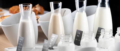 Various milk bottles and bowls on a table.