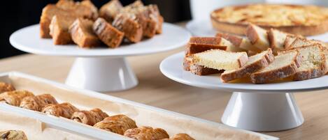 A variety of baked goods displayed on white stands.