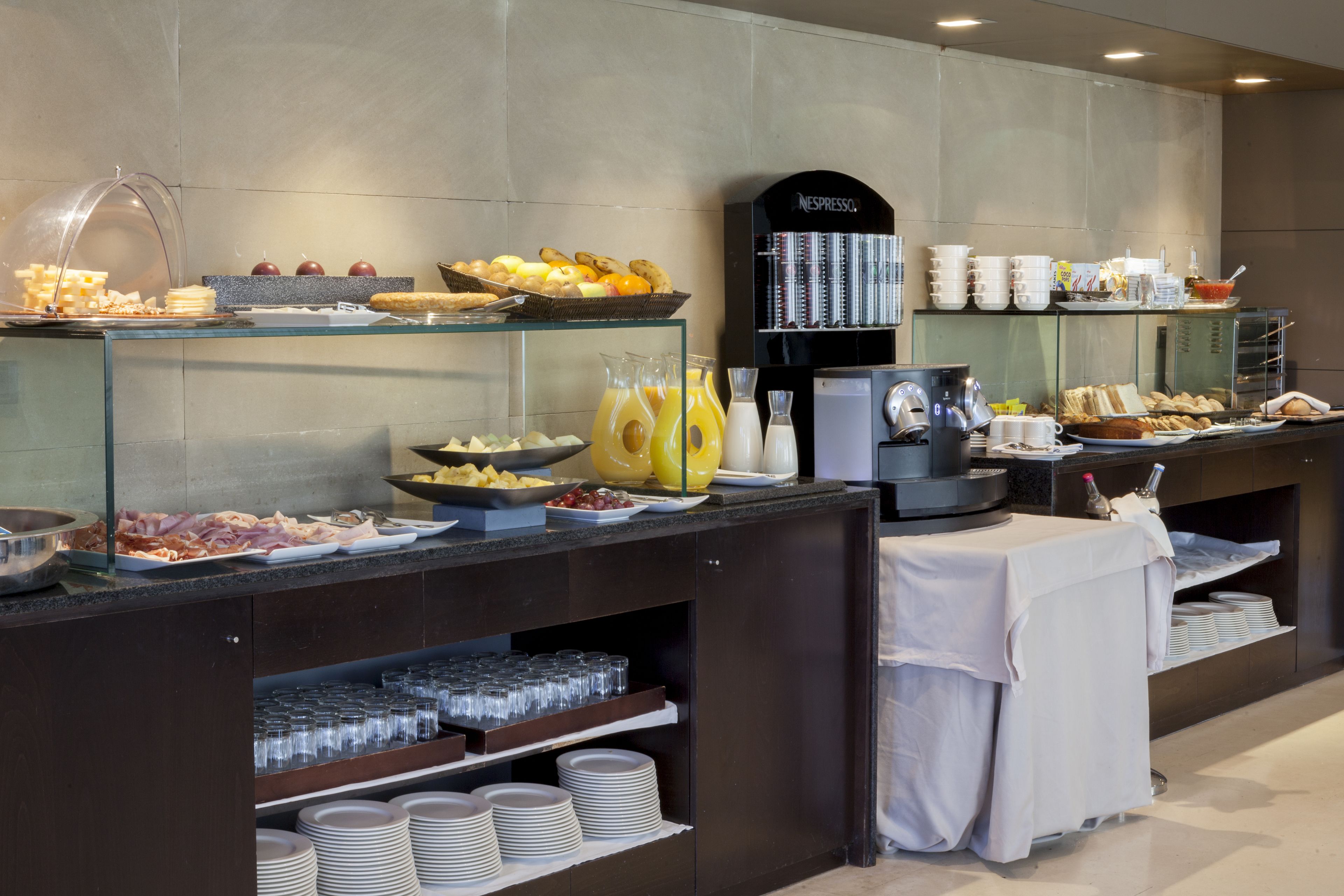 A buffet with various food items and a coffee machine.