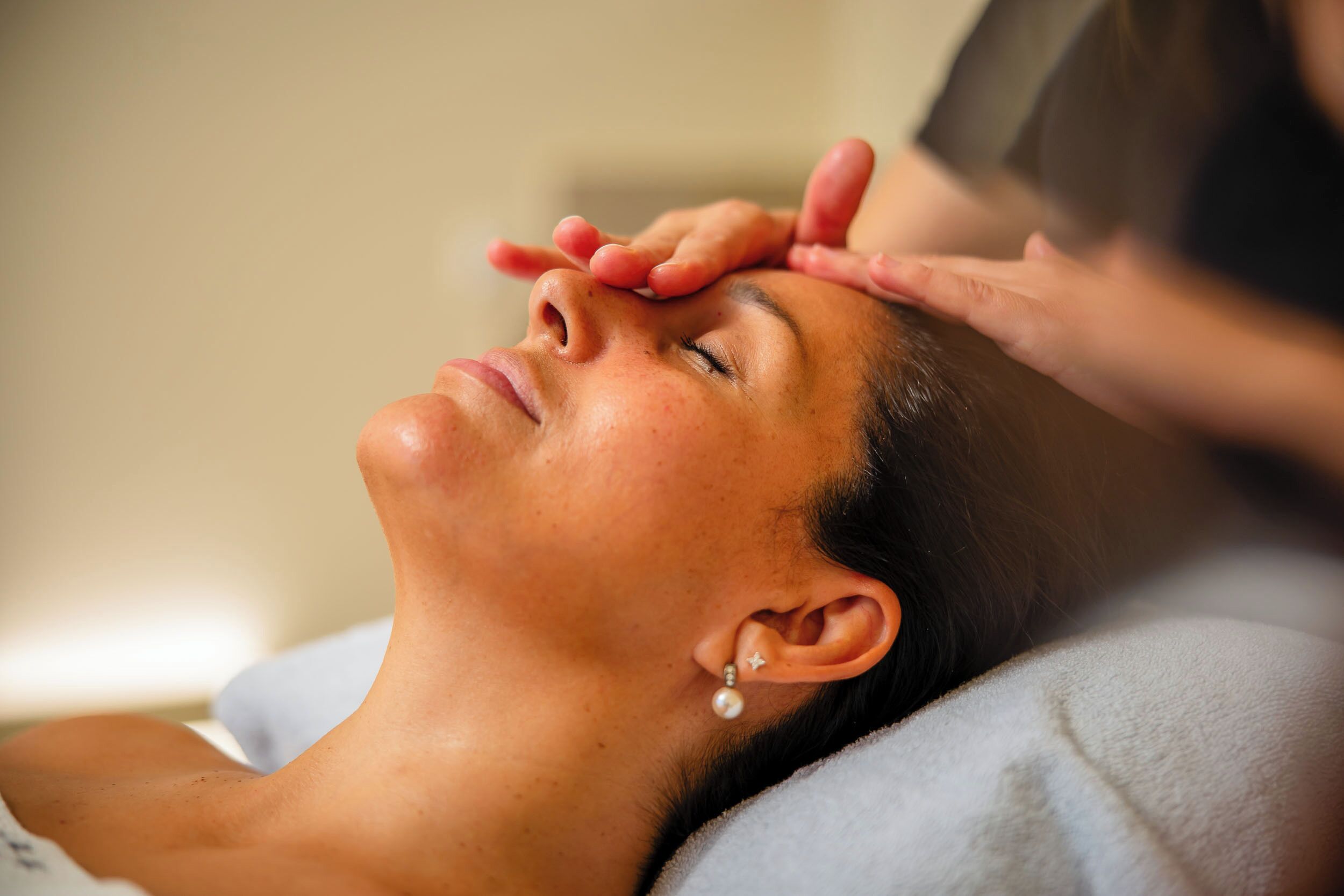 A person receiving a head massage.