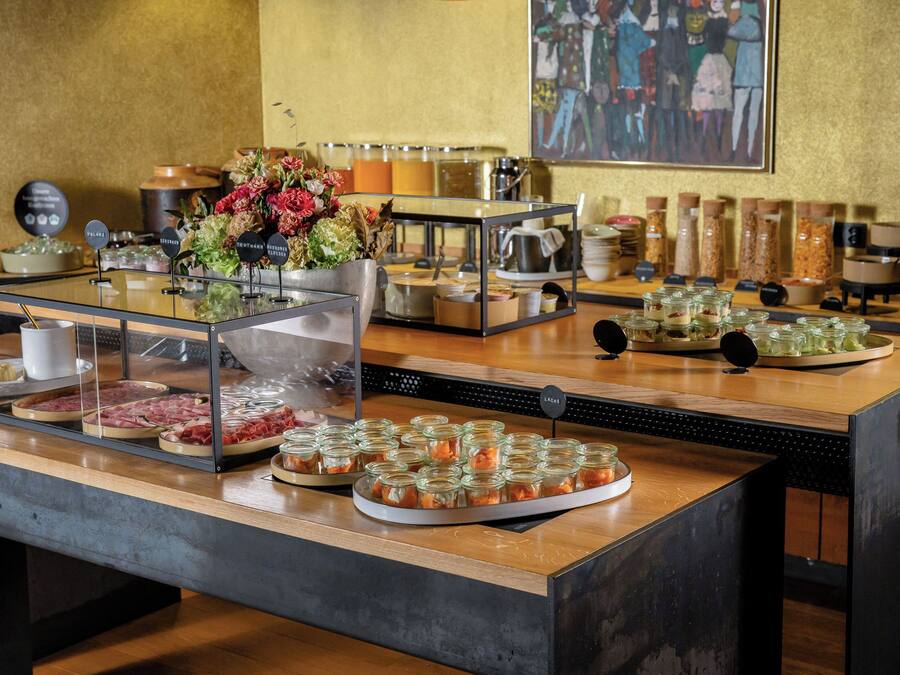 A buffet setup with various food items and condiments.