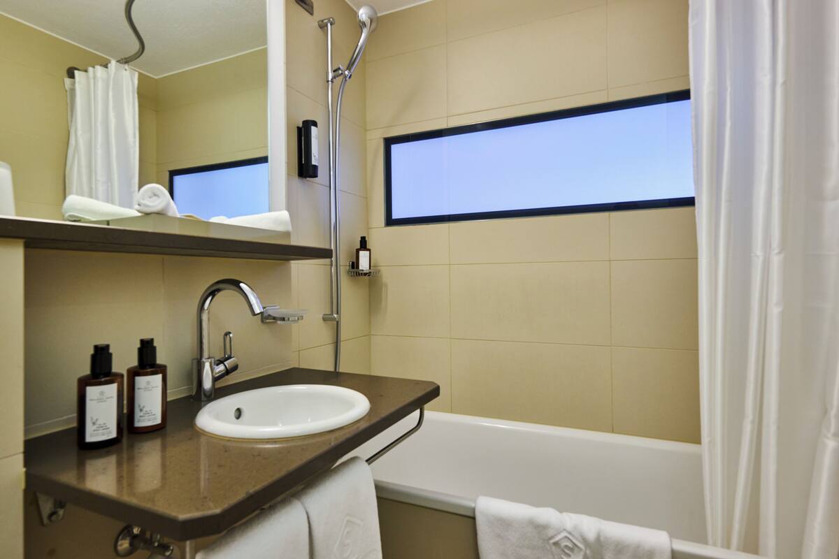 designer toiletries, hair dryer, bathrobes, slippers