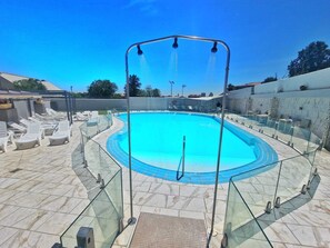 Seasonal outdoor pool, open 11:30 AM to 7:30 PM, pool loungers