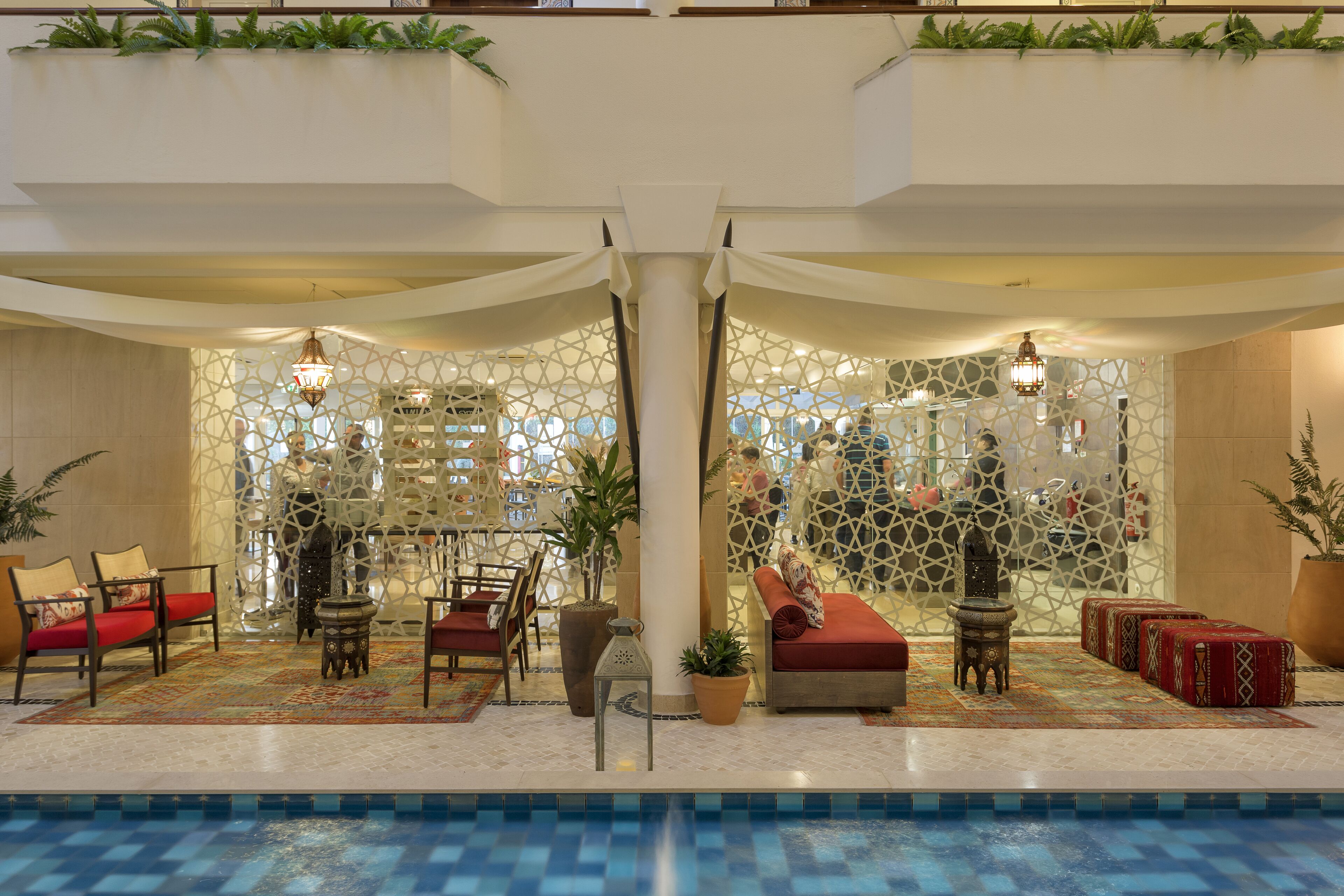 A pool area with seating and decorative elements.