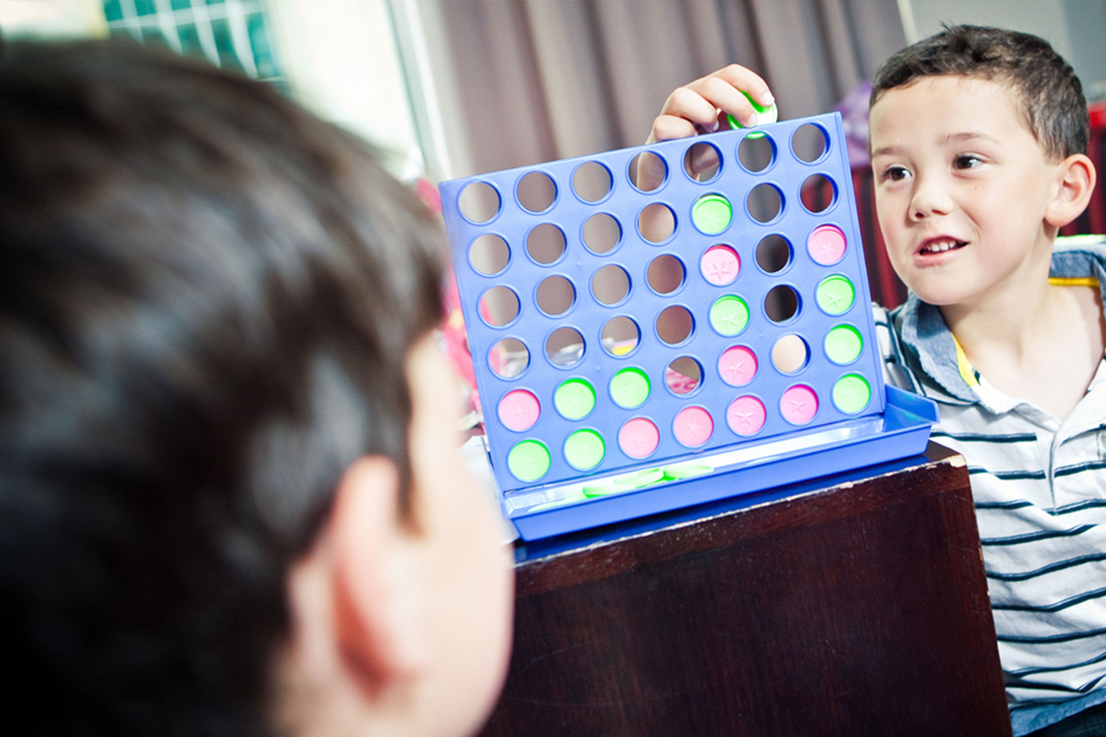 A child playing with a colorful pop-it toy.