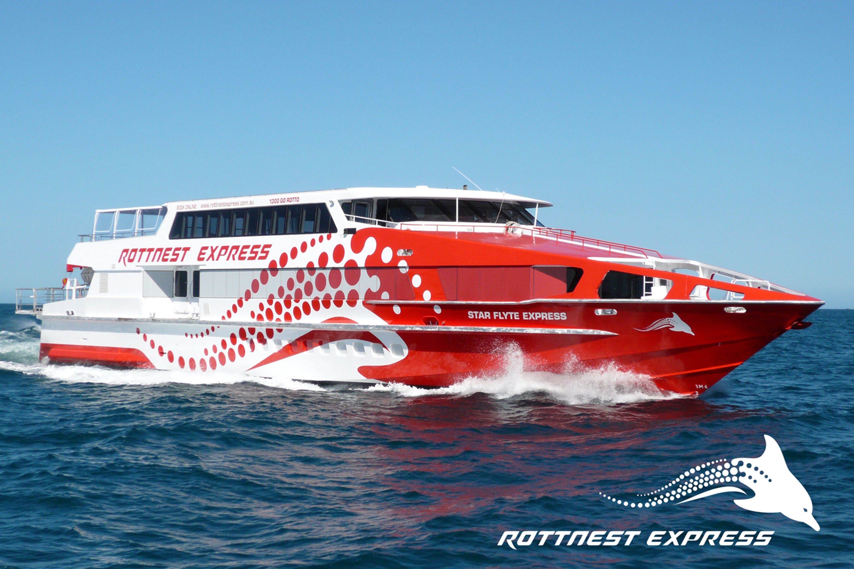 A red and white boat with the name "Star Flyte Express" on the side, traveling on the water.