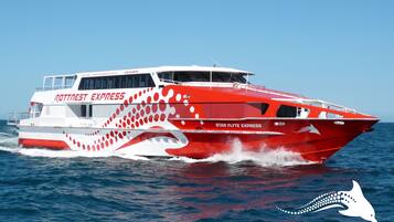 A red and white boat with the name "Star Flyte Express" on the side, traveling on the water.