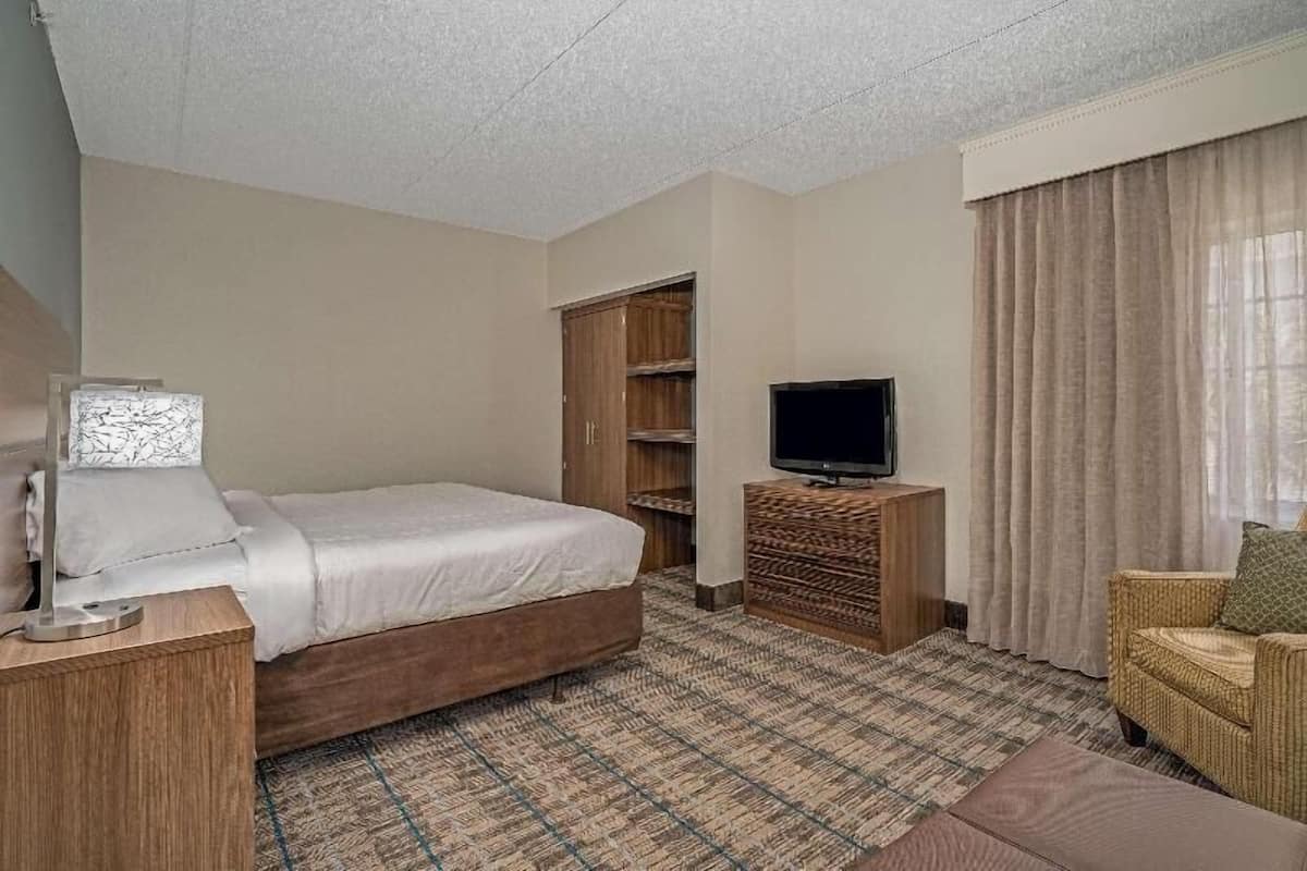 Premium bedding, desk, laptop workspace, blackout drapes