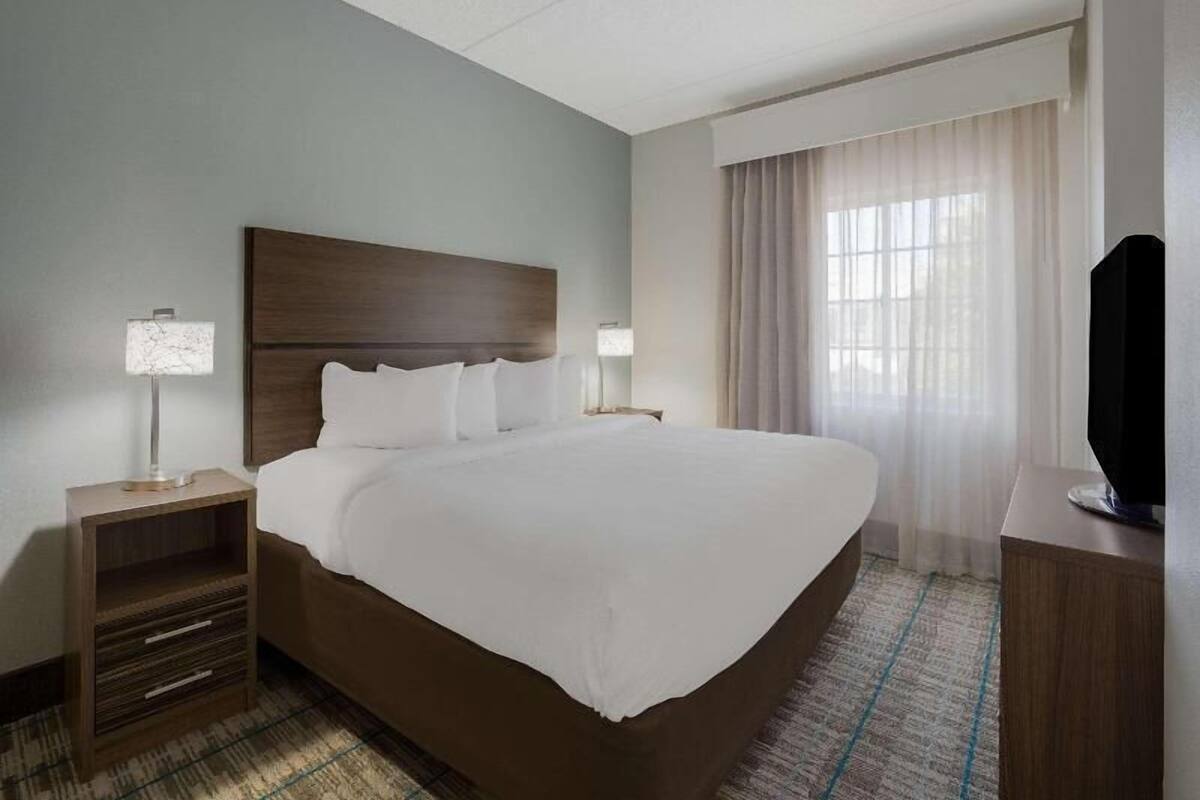 Premium bedding, desk, laptop workspace, blackout drapes