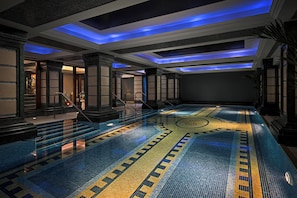 A large indoor swimming pool with a tiled floor and blue lighting on the ceiling. - Killarney Plaza Hotel and Spa (Killarney)