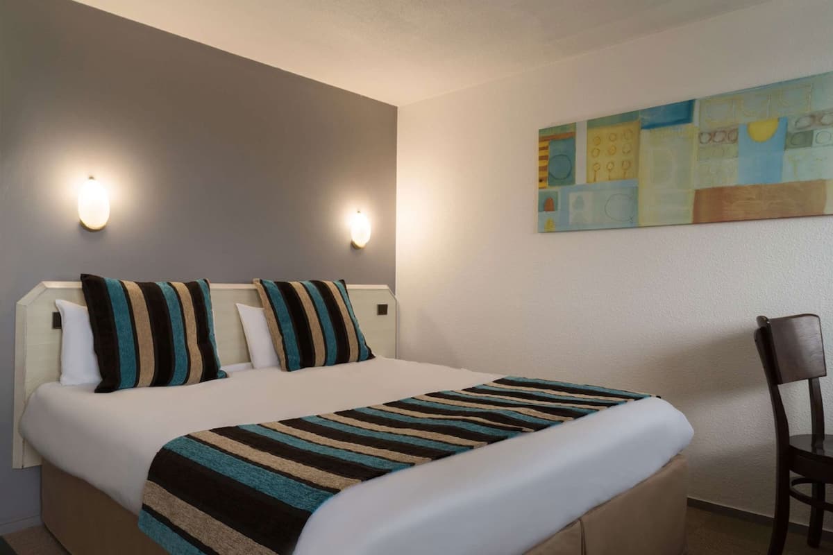 Premium bedding, desk, laptop workspace, blackout drapes