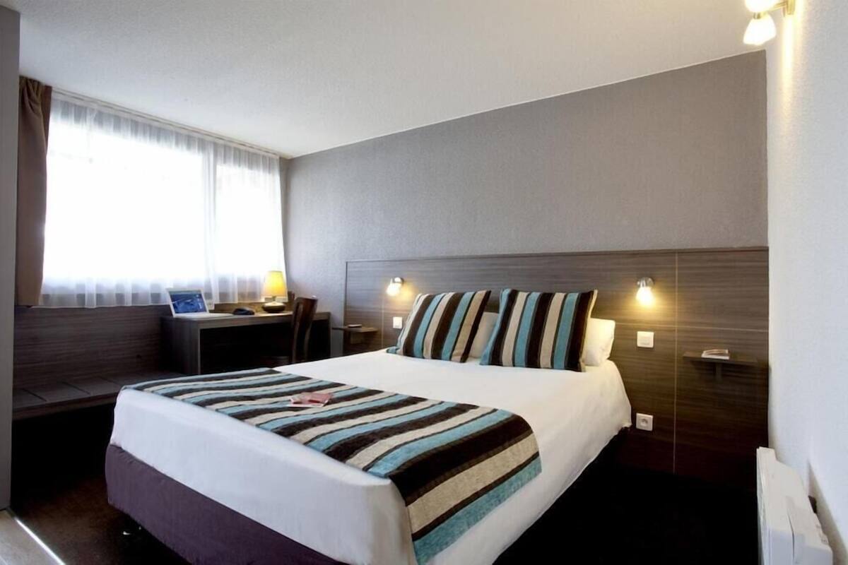 Premium bedding, desk, laptop workspace, blackout drapes