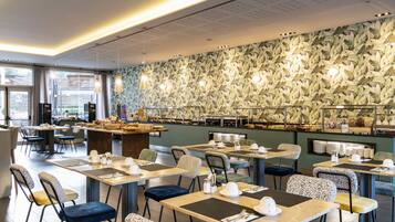 A restaurant with a buffet, tables, chairs, and a patterned wall.