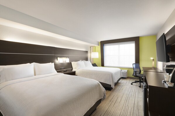 A hotel room with two beds, a desk, a chair, a TV, and a window with blinds. - Holiday Inn Express Sarasota East - I-75 by IHG (Sarasota)