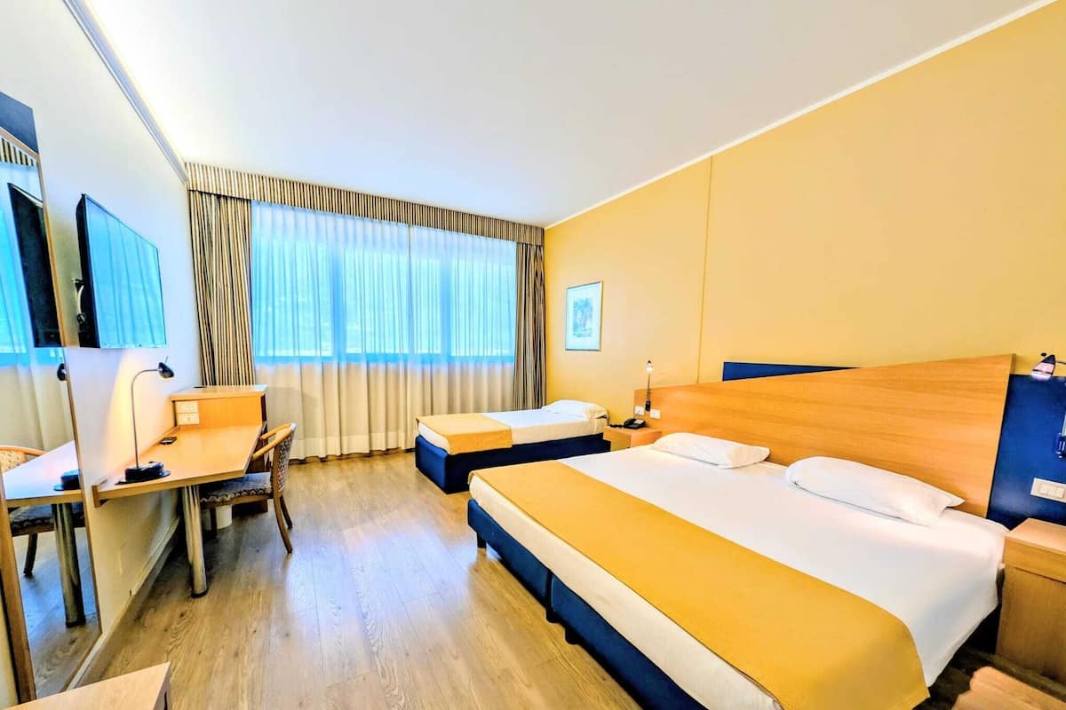 Superior Triple Room | Minibar, desk, blackout drapes, iron/ironing board