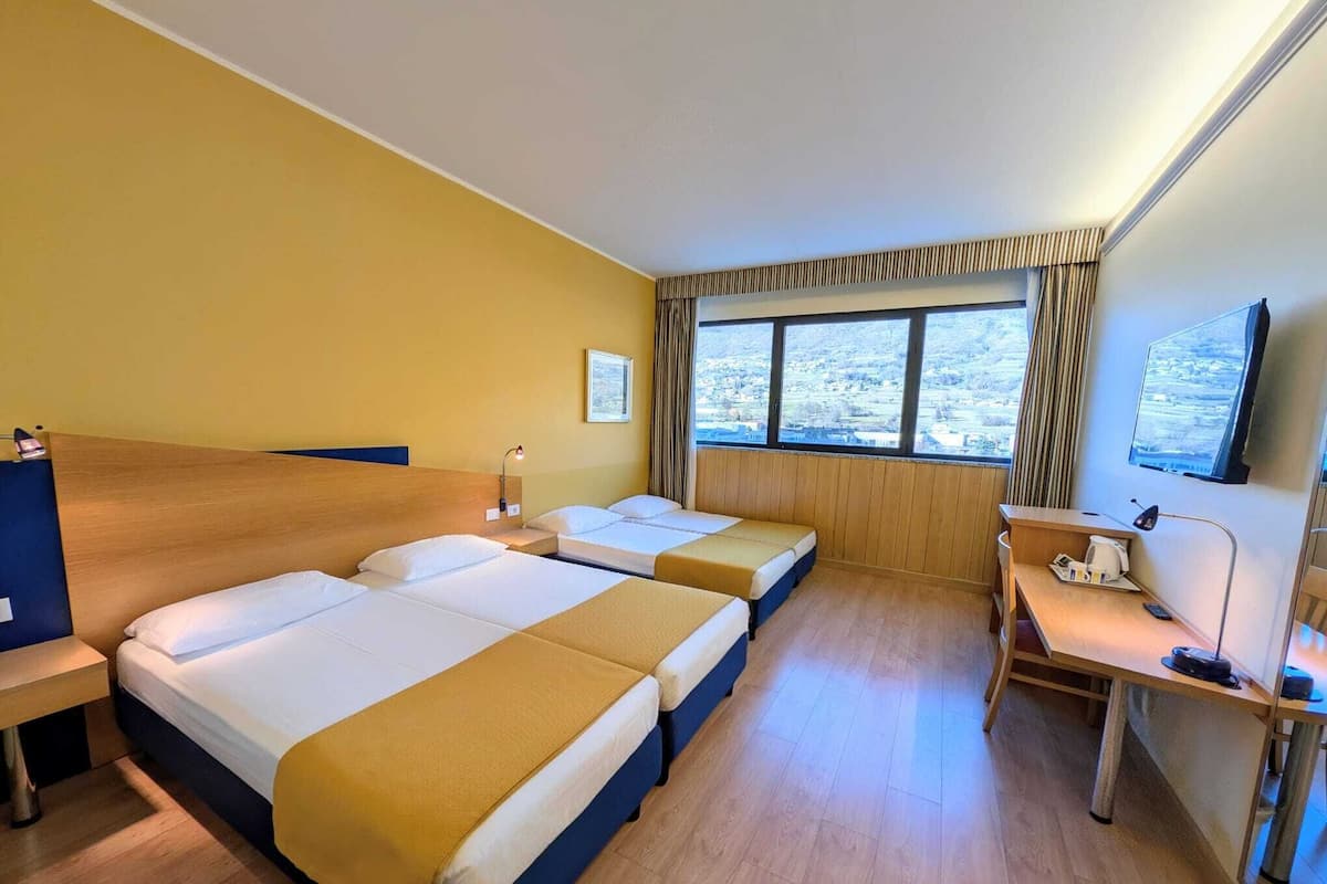 Superior Quadruple Room | Minibar, desk, blackout drapes, iron/ironing board