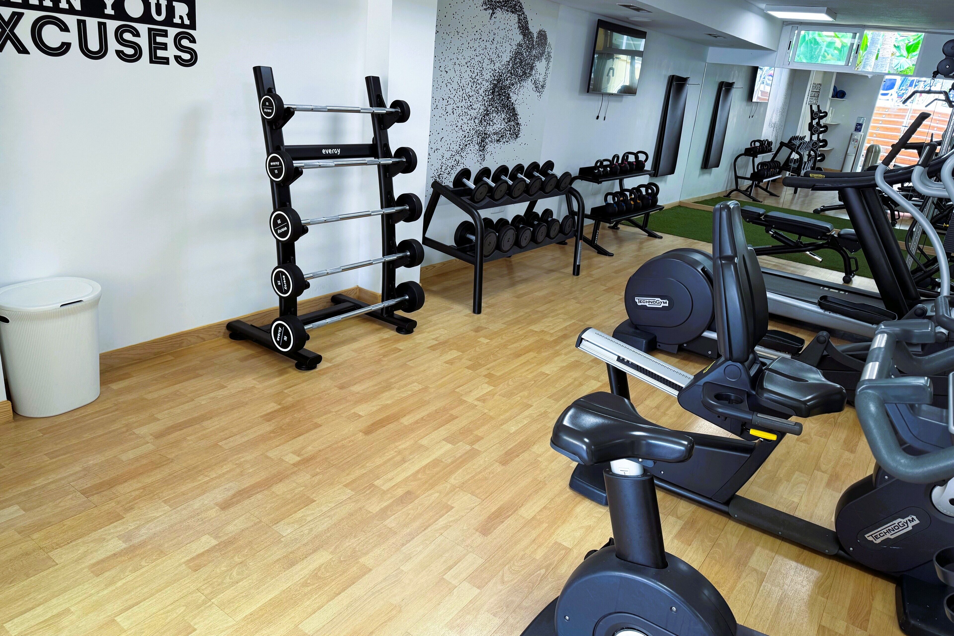 A gym with exercise equipment, including treadmills and weight machines.