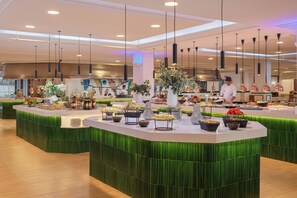 A buffet setup with various food items and a chef preparing food. - H10 Lanzarote Princess (Yaiza)