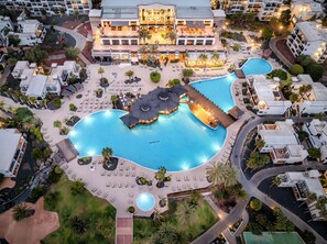 An aerial view of a resort with multiple swimming pools, sun loungers, and a large building with outdoor seating. - H10 Rubicón Horizons Collection (Yaiza)