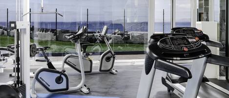 A gym with treadmills, elliptical machines, and weight equipment.