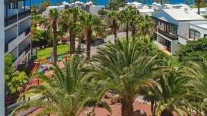 A resort with multiple-story buildings, palm trees, and a view of the ocean. - H10 Rubicón Horizons Collection (Yaiza)