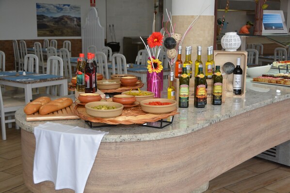 A buffet setup with various food items and beverages. - HL Paradise Island (Yaiza)