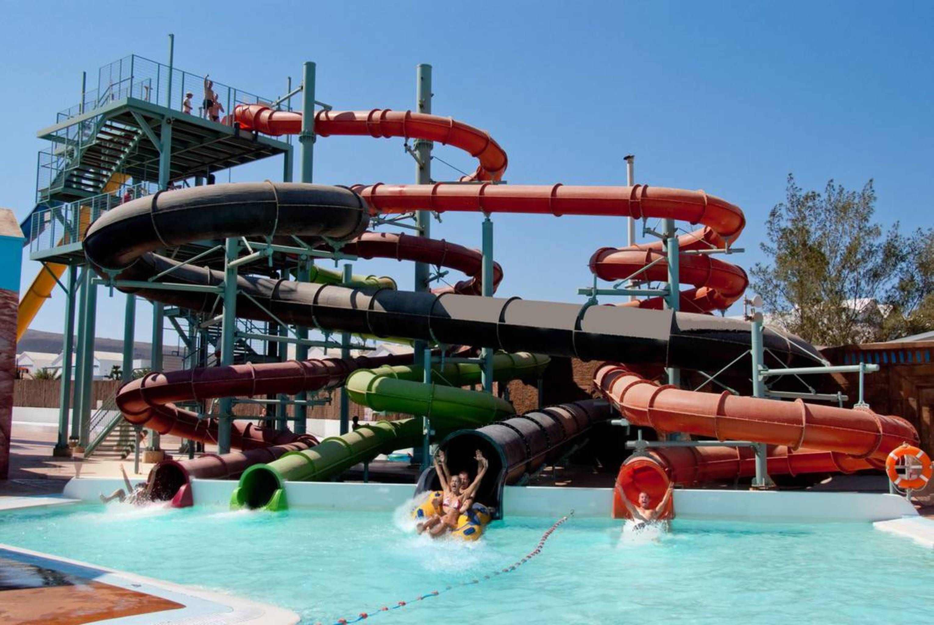 A water park with multiple slides and a pool area.