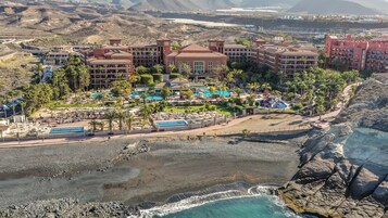 On the beach, black sand, beach towels