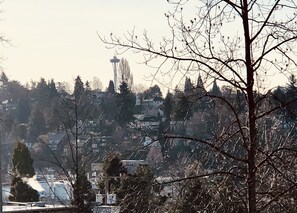 A view of a town with a prominent tower, surrounded by trees and buildings.