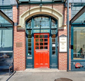 A red door with a sign reading "College Inn" above it.