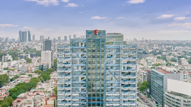 A modern high-rise hotel with a distinctive blue facade and a prominent 'FIesta Inn' sign. - Fiesta Inn Insurgentes Viaducto (Mexico City)