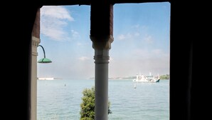 A view of a body of water with a boat and distant buildings. - Russo Palace Hotel (Venice)