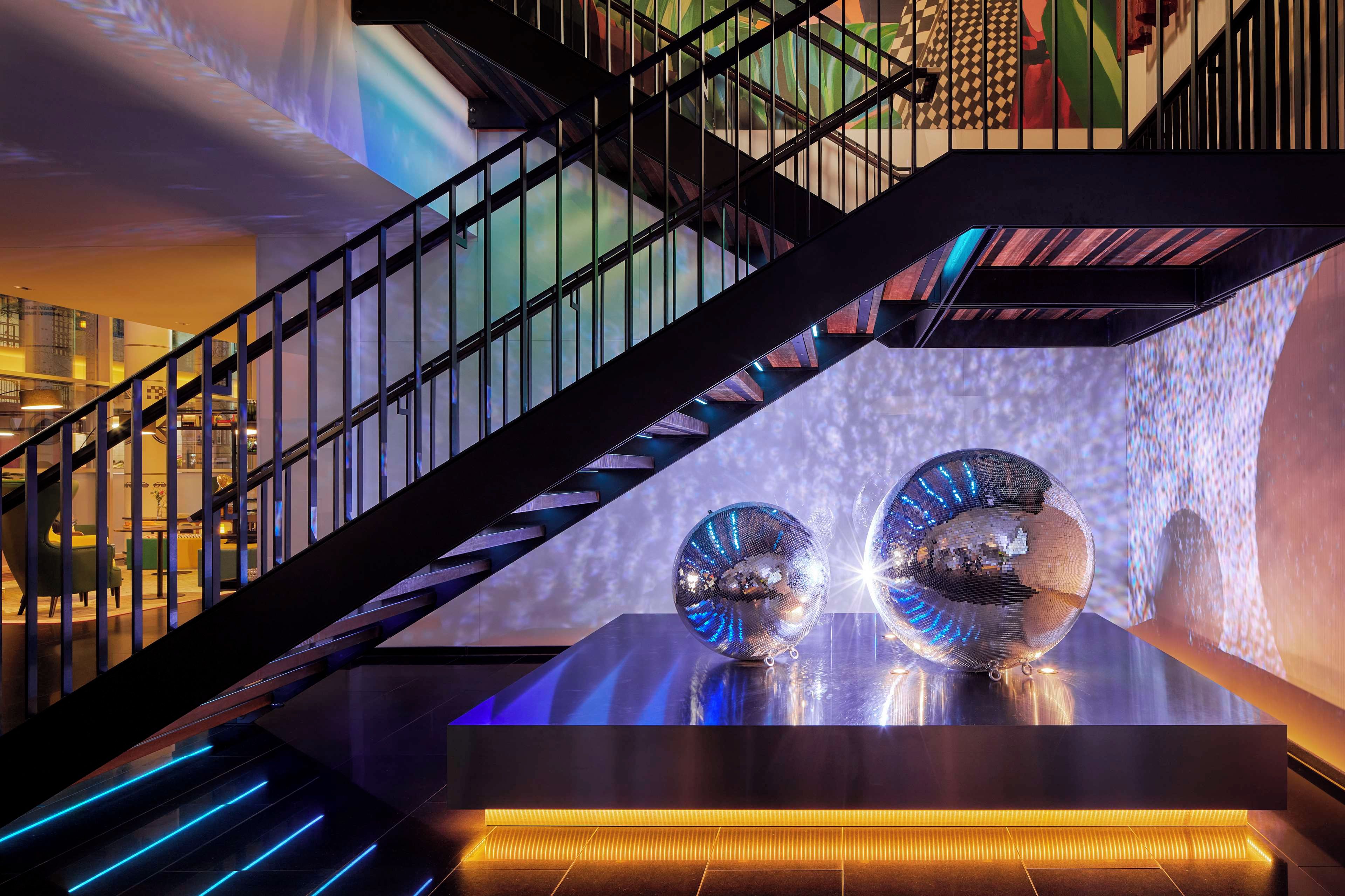A modern staircase with a glass railing, leading to a lower level.