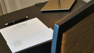 Un mostrador de hotel con una computadora portátil, un bolígrafo y un documento titulado 'HOTEL & SPA LE SPLENDID'.