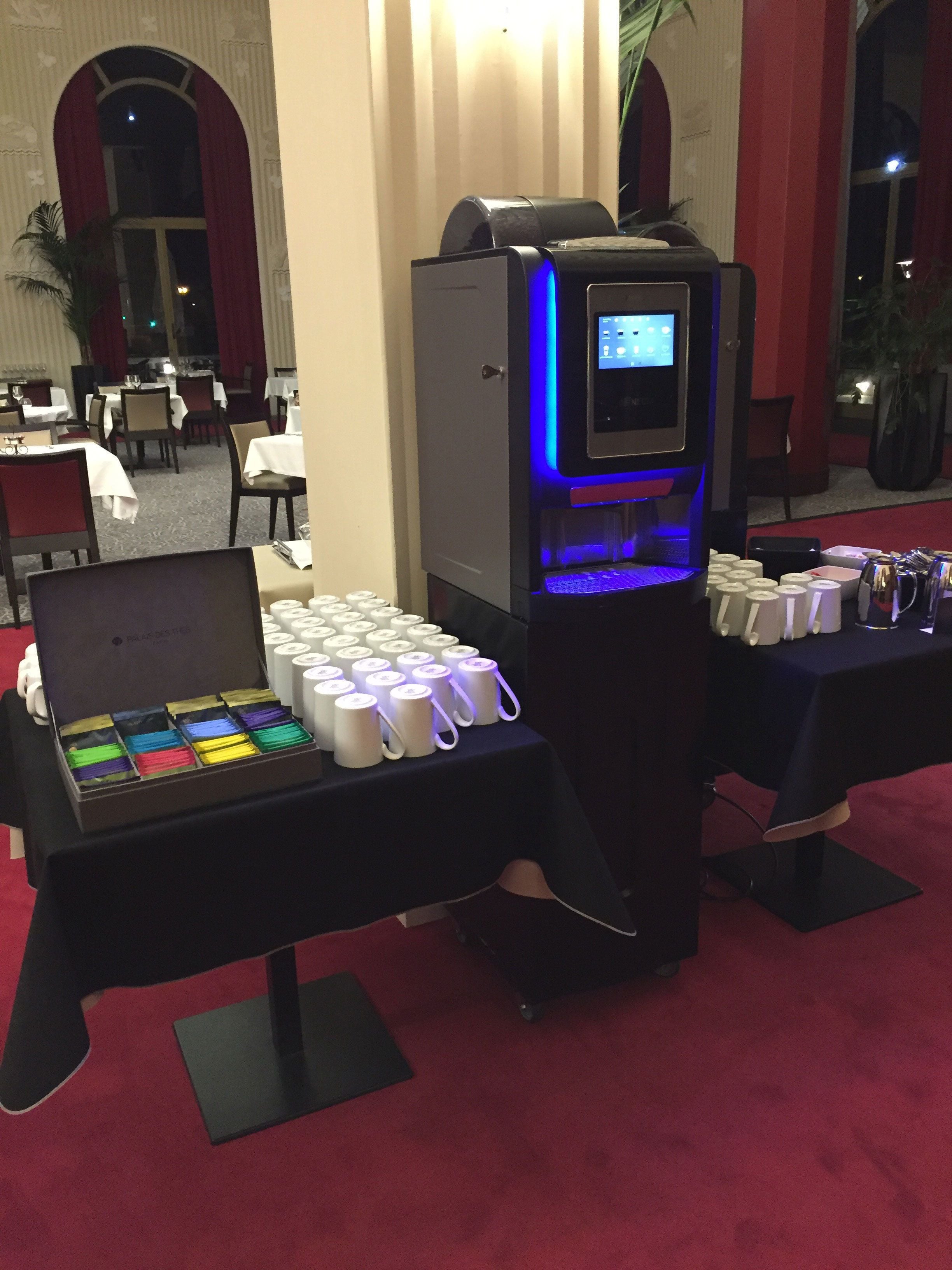 A self-service beverage station with a selection of colorful drinks and a digital display.