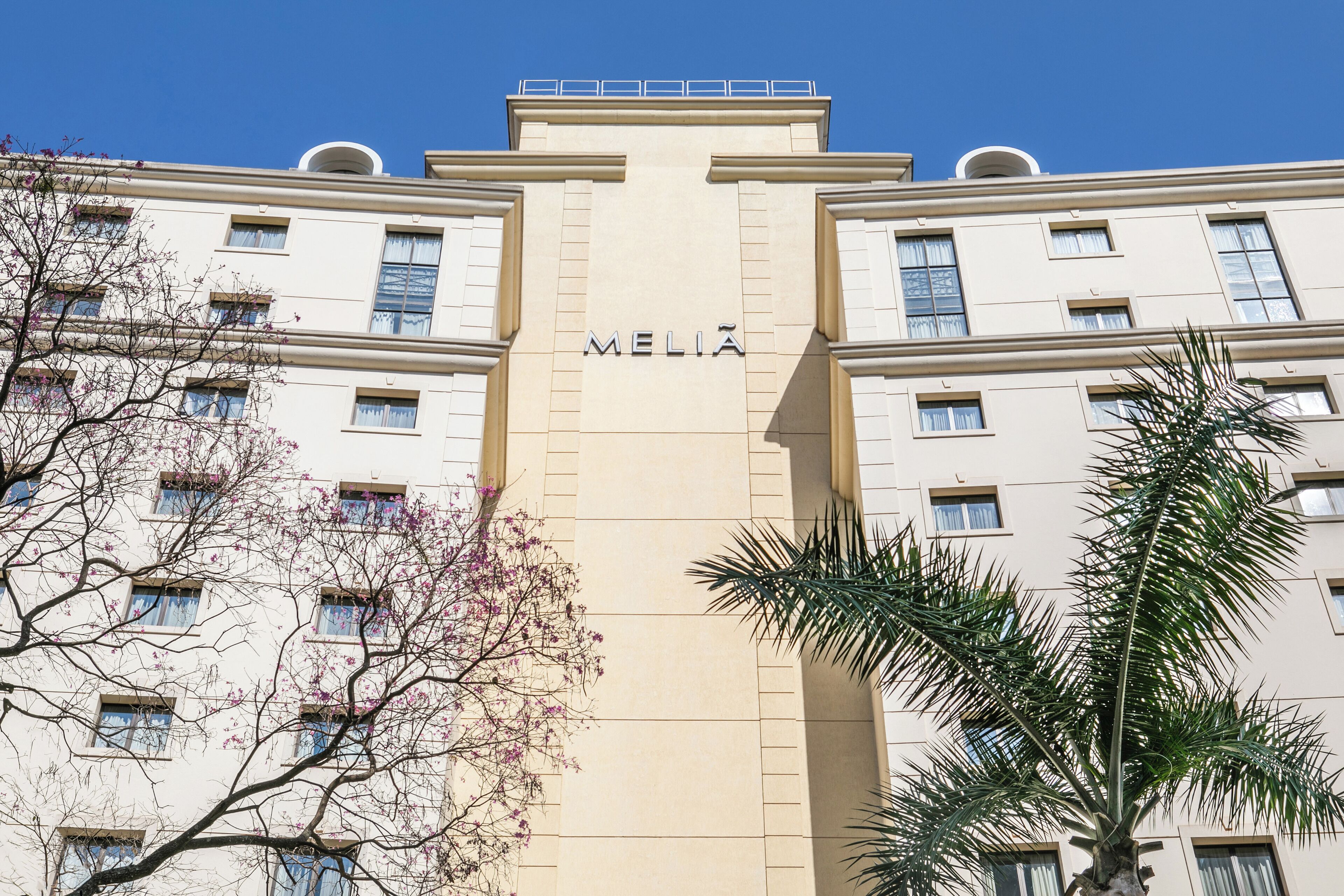 A multi-story building with the name "MELIA" prominently displayed on the facade.
