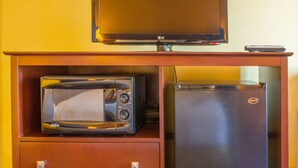 A compact kitchenette with a microwave, refrigerator, and a television on a wooden cabinet. - Holiday Inn Express & Suites Richland by IHG (Richland)