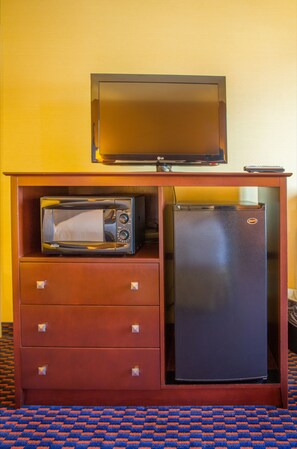 A compact kitchenette with a microwave, refrigerator, and a television on a wooden cabinet. - Holiday Inn Express & Suites Richland by IHG (Richland)
