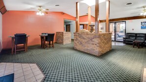 A lobby with a reception desk, seating area, and a fireplace. - Motel 6 Marion, IL (Marion)