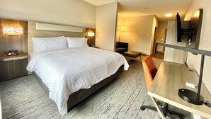 A hotel room with a large bed, bedside tables, a desk with a chair, a flat-screen TV, and a lamp. - Holiday Inn Express & Suites Elyria by IHG (Elyria)