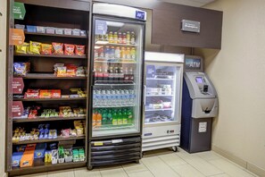 A vending machine with snacks, a beverage cooler, and an ATM. - Concord Suites (Concord)
