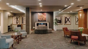 A lobby with seating areas, a fireplace, and framed artwork on the walls. - Club Quarters Hotel Embarcadero, San Francisco (San Francisco)