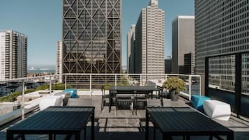Enjoy al fresco dining or relaxation on this rooftop terrace with city views.