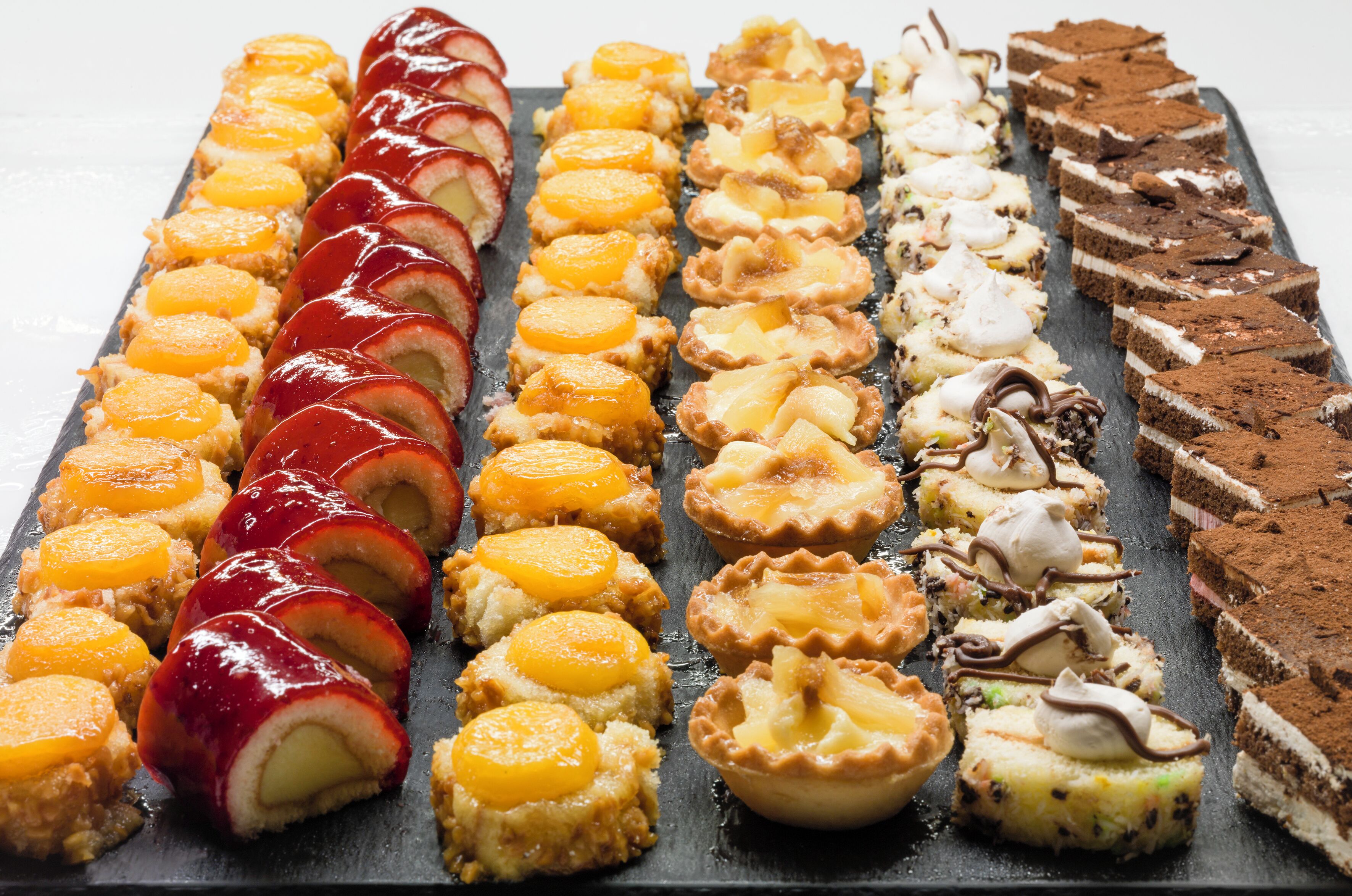 Una variedad de postres dispuestos sobre una pizarra.