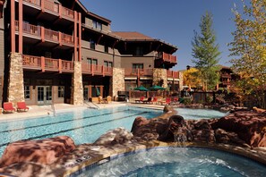 A hotel with a swimming pool, outdoor seating, and a hot tub. - Ritz-Carlton Club, Aspen Highlands by Frias (Aspen)