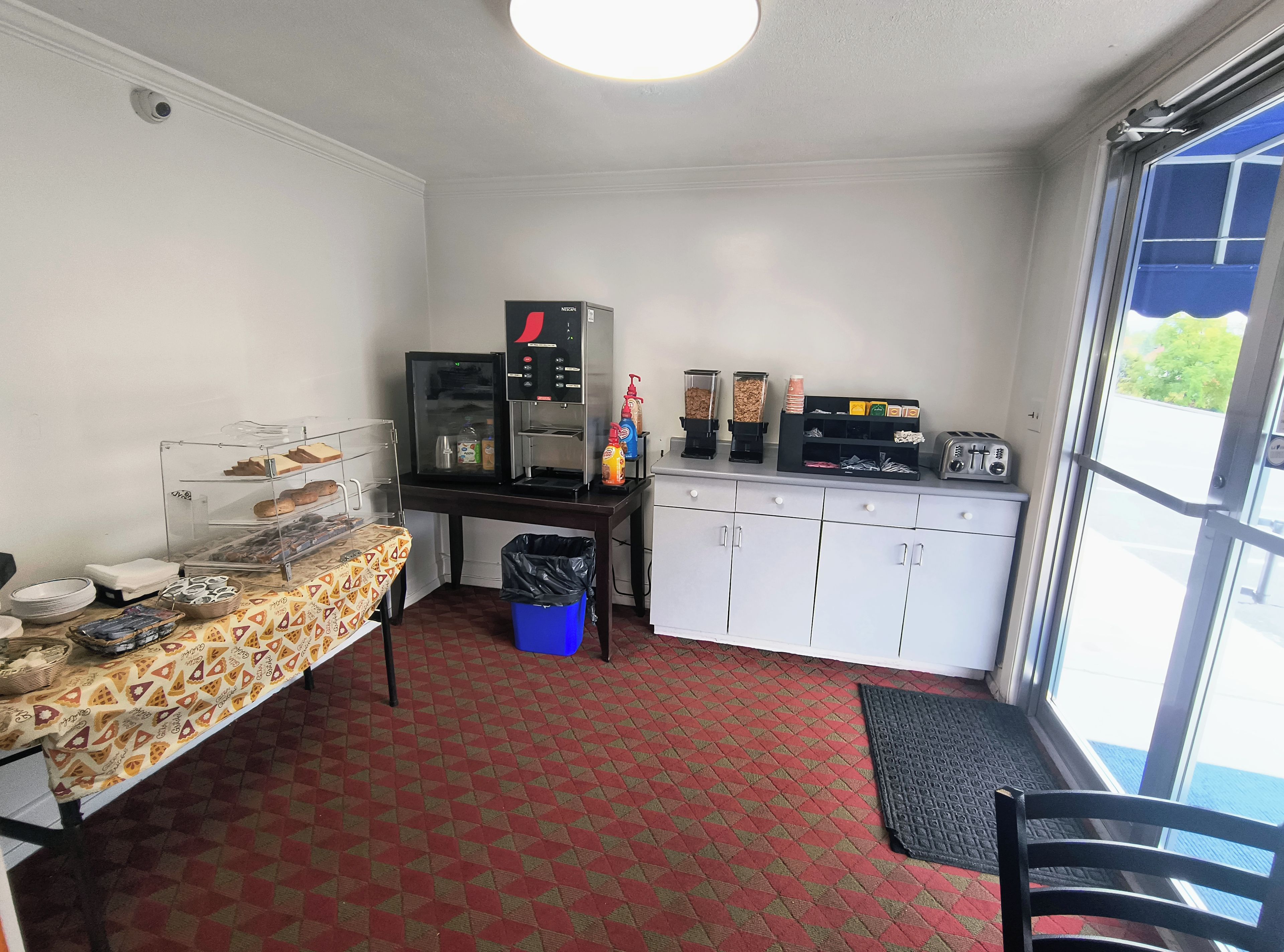 A kitchenette with a coffee machine, toaster, and food dispensers.