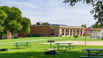 A building with a brick facade, large windows, and a flat roof.