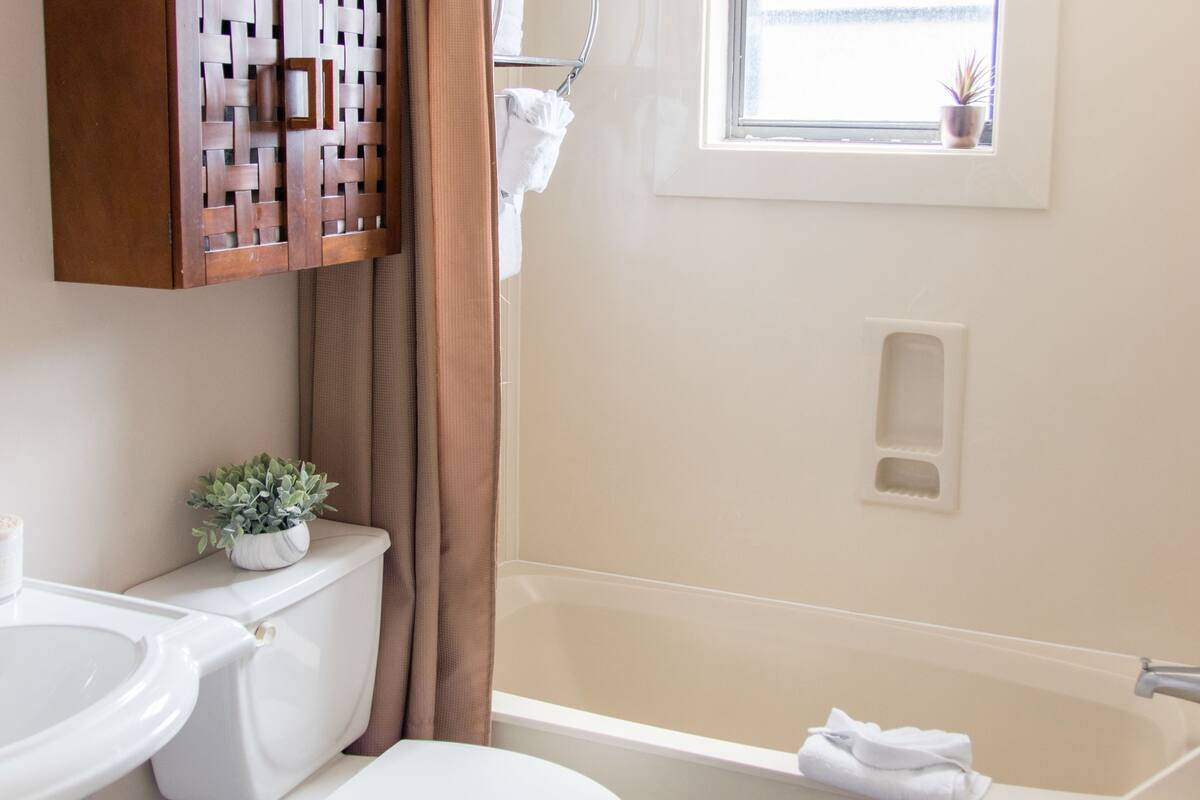 combined shower/bathtub, rainfall showerhead, designer toiletries