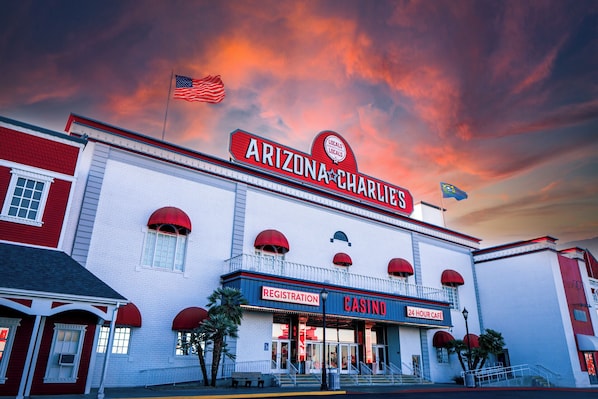 A building with a red and white facade, a sign reading "ARIZONA CHARLIE'S", and a "CASINO" sign below. - Arizona Charlie's Decatur (Las Vegas)