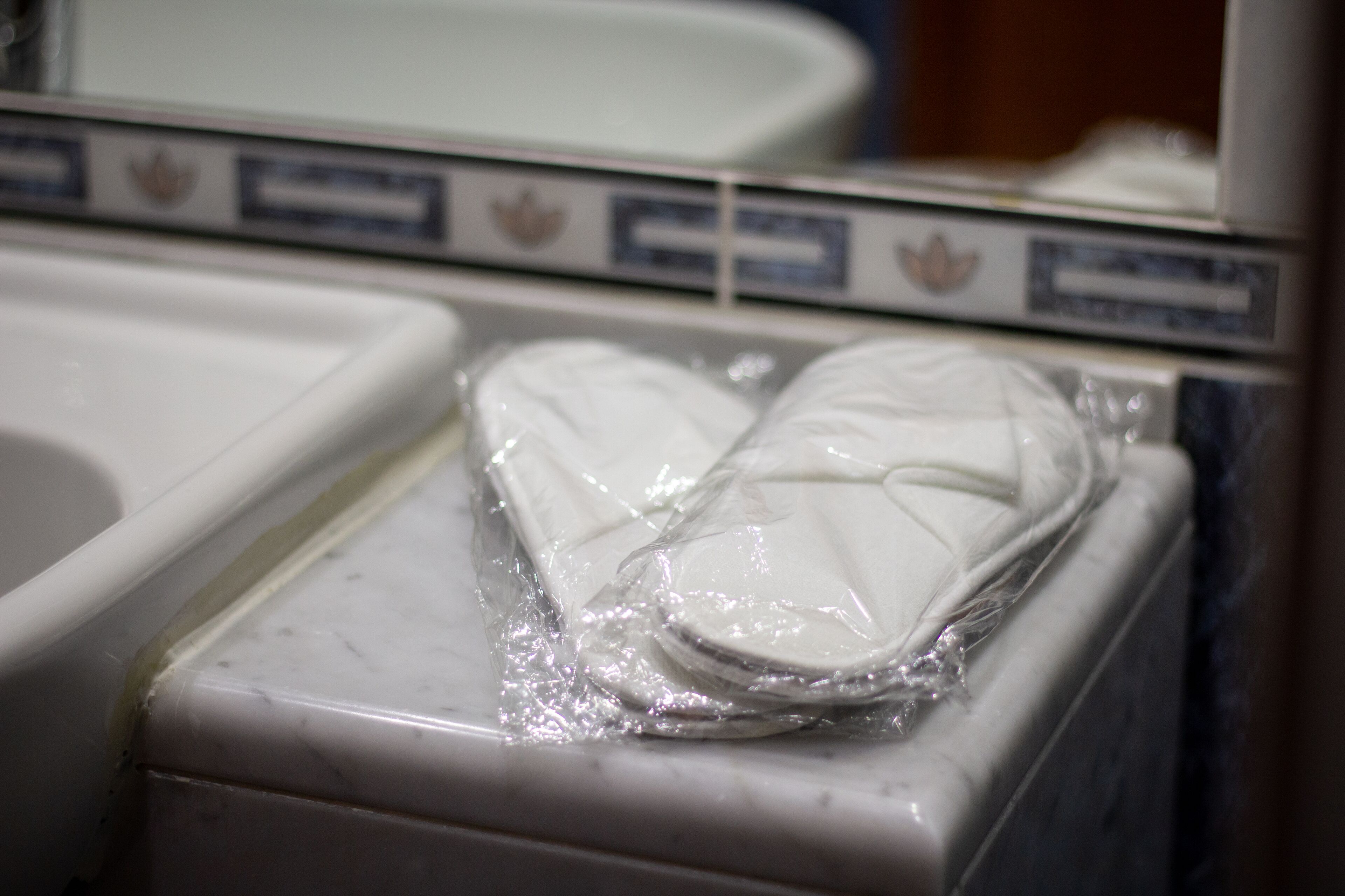A bathroom with a white sink and a tiled backsplash.